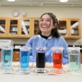 Student smiling behind hematology stains