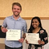 Emil Johnson and Melanie Thomas holding award certificates.