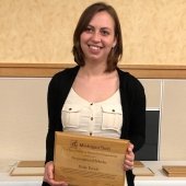 Holly Eyrich holding award.