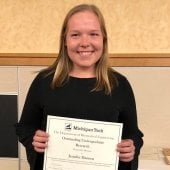 Jennifer Hannon holding an award certificate.