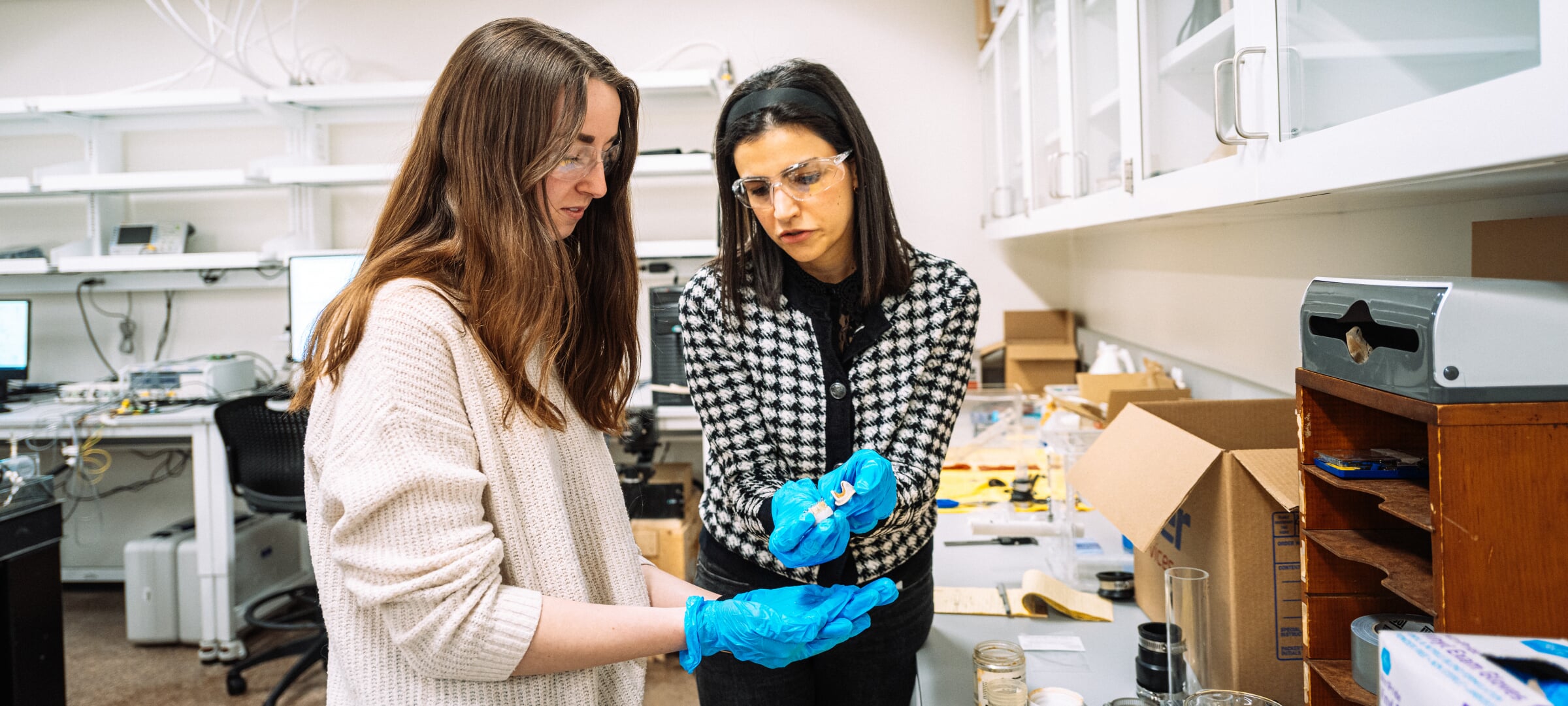 A student examining something in someone's hand