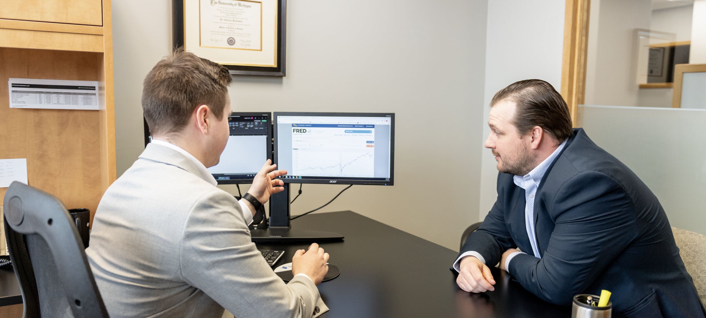 Business analyst confers with client