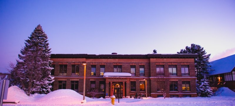 View of the front of the Academic Office Building in the winter