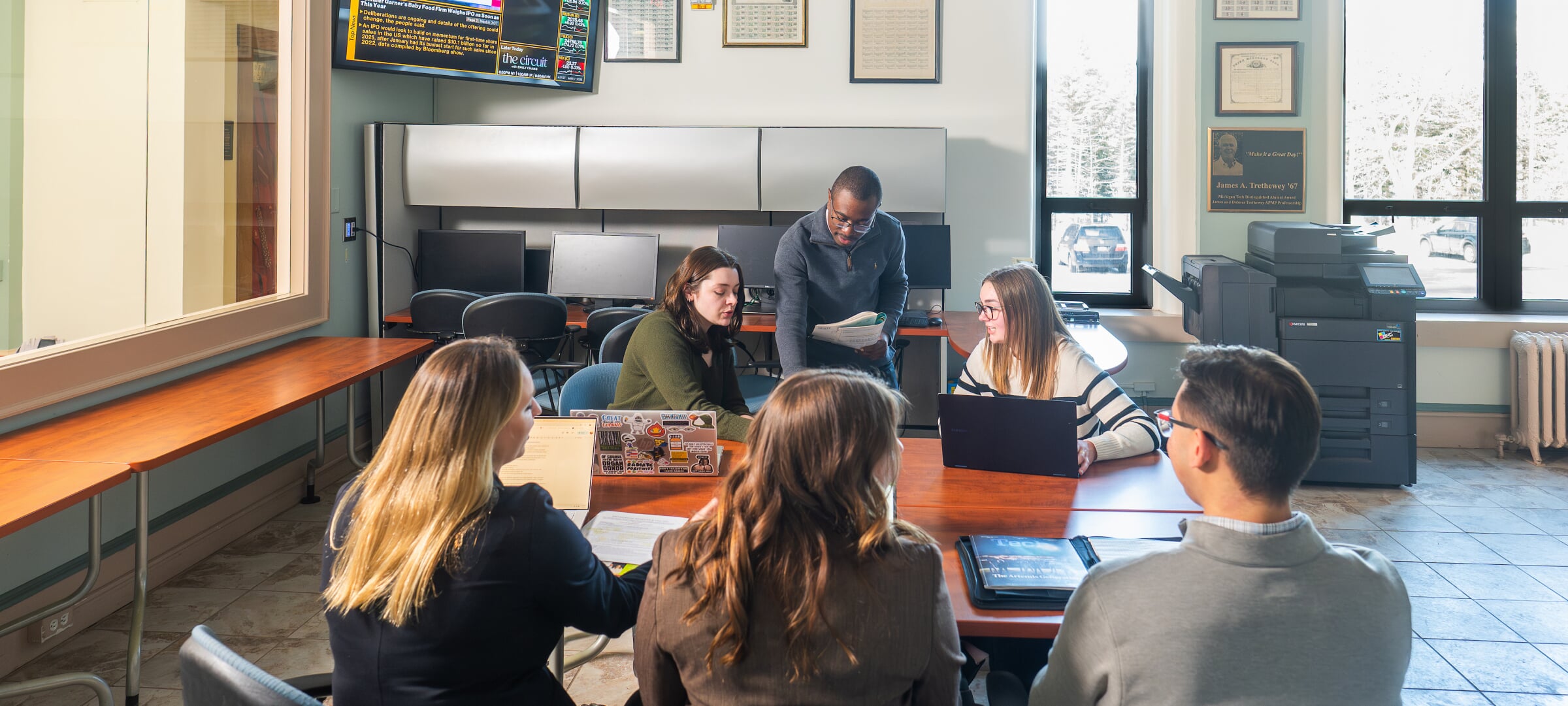 Students around a conference table discussing