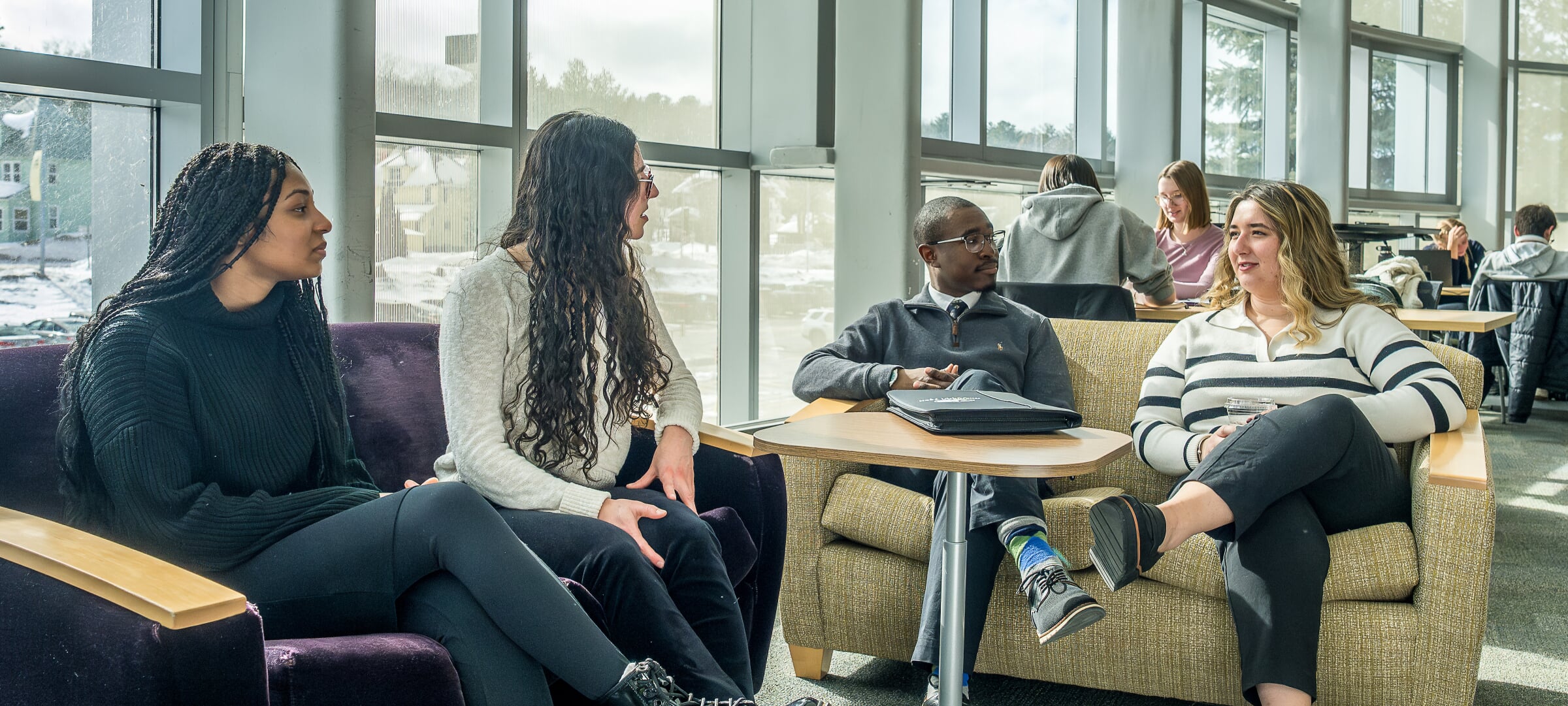 Group of business students sitting together talking.