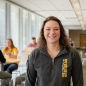 Student standing in the Library.