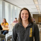 Student standing in the Library.