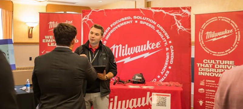 Student speaker to a recruiter at the Milwaukee Tool both.