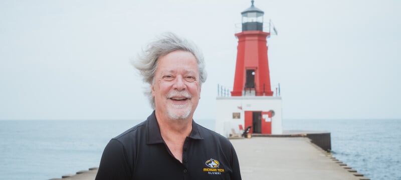 Greg Horvath outdoors in front of a lighthouse.
