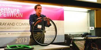 Student holding up a bike tire at the competition