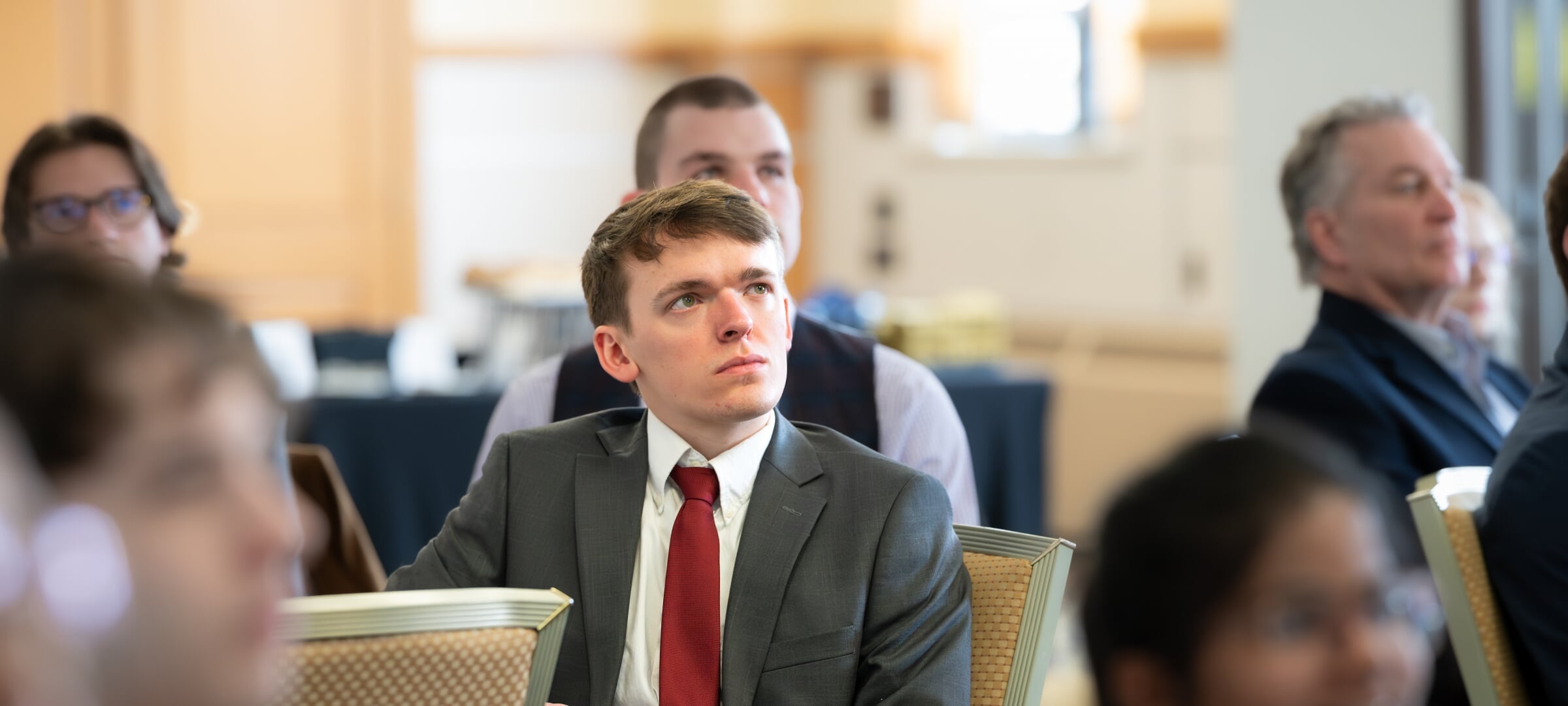 A student listens intently to a presentation