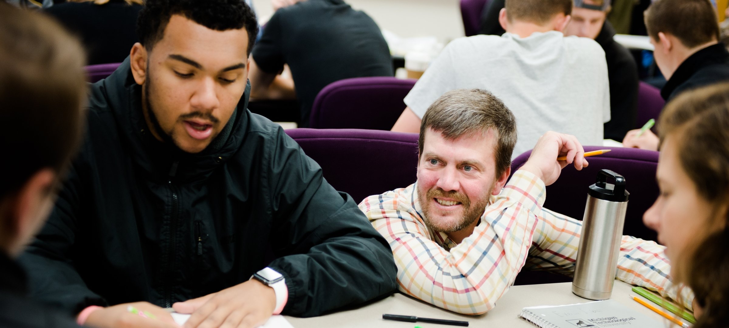 Students working on project with instructor