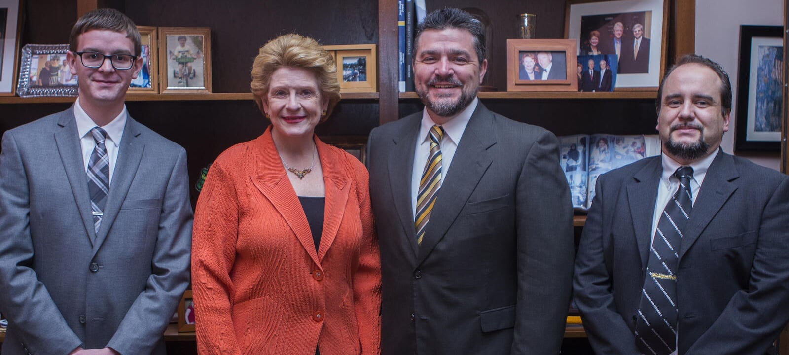 Student Jerrid Burdue, Debbie Stabenow, Dean Johnson and Emanuel Oliviera posing and smiling