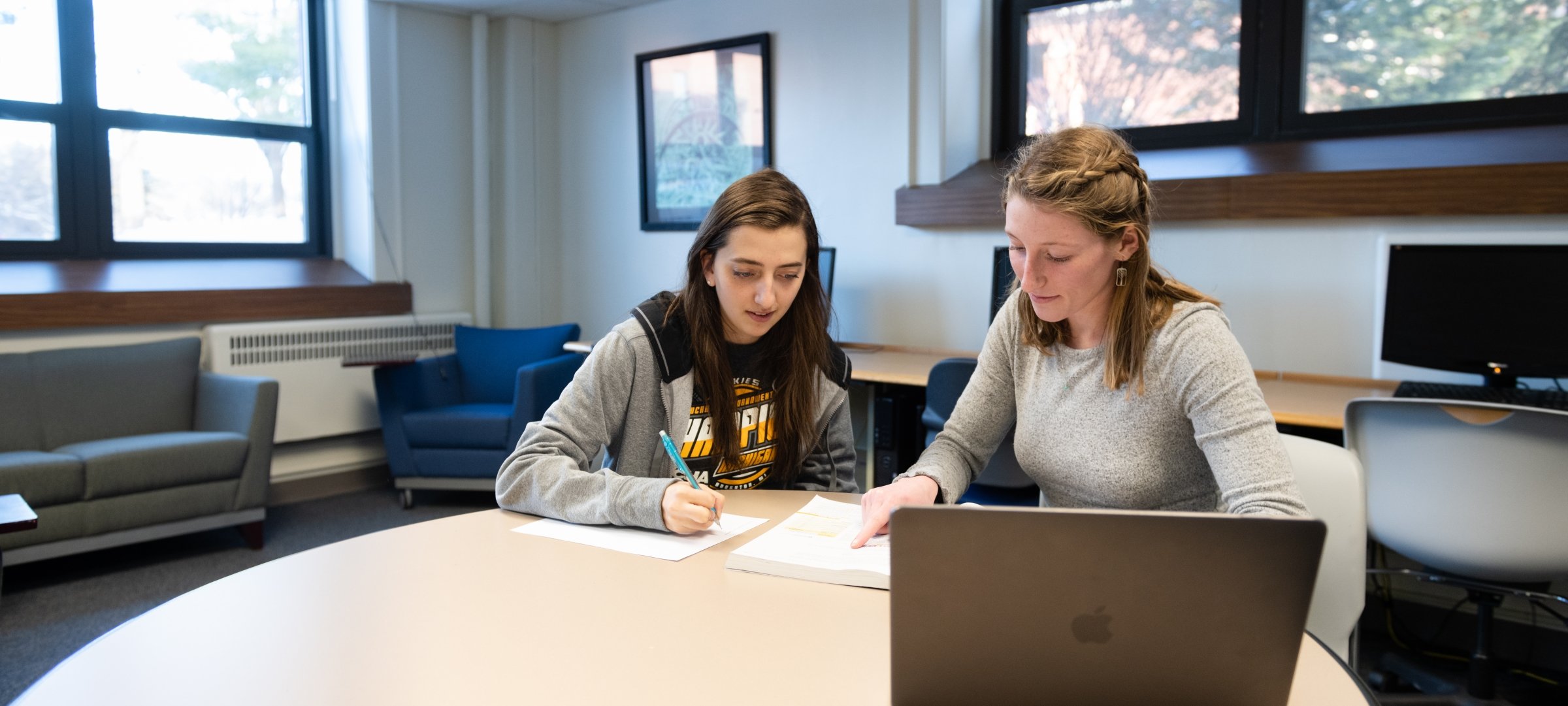 Two people studying in a computer lab