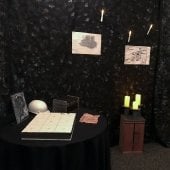 Photo of mine themed escape room. Candles, puzzle and lock box pictured.