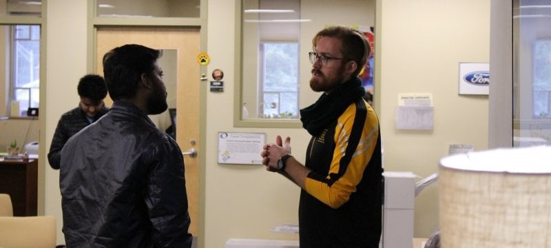 Career Advisor helping student working on laptop