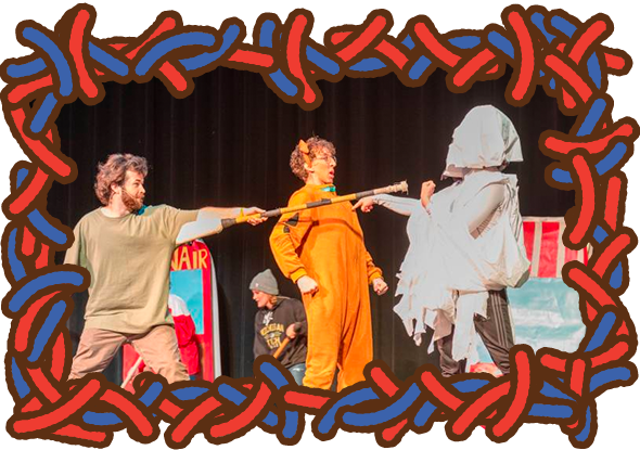 Performers on stage dressed in costumes in accusatory poses