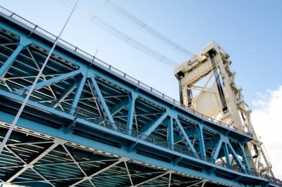 A view from the water looking up at the Portage Lake Lift Bridge.