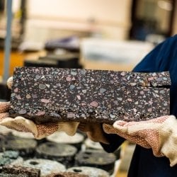 A piece of asphalt held by a researcher.