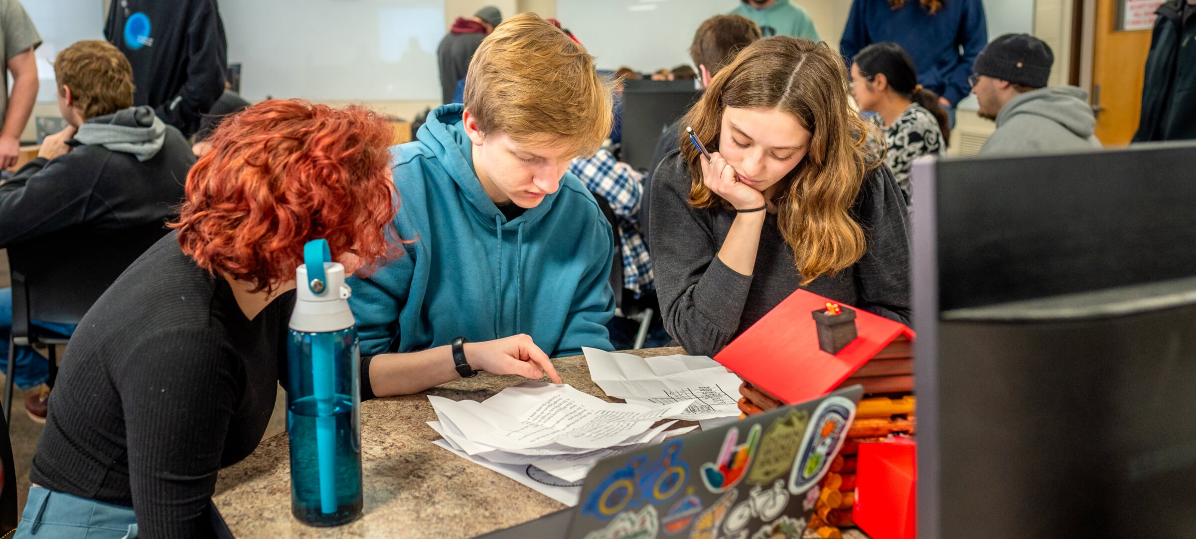 Students working and looking at papers