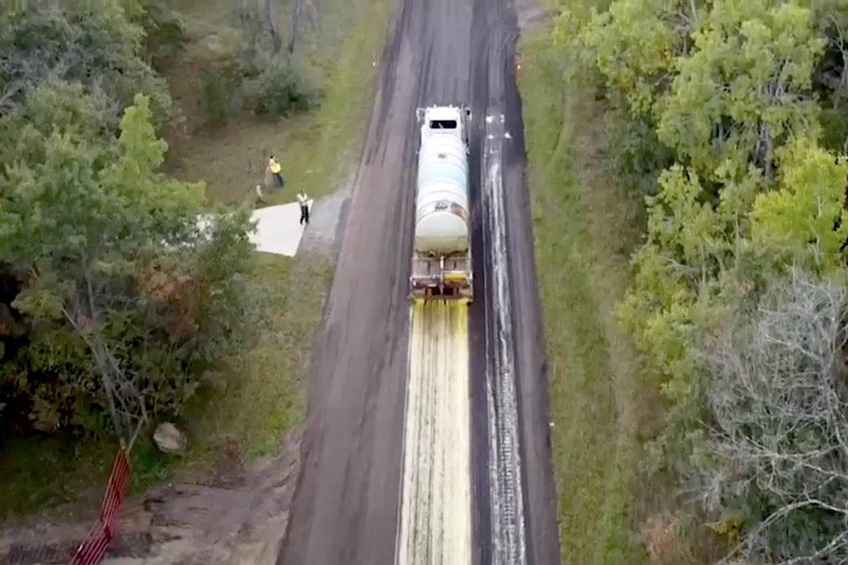 Truck adding soybean oil to the pavement.