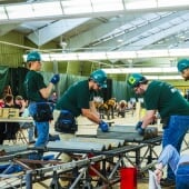 Students working on a steel bridge frame