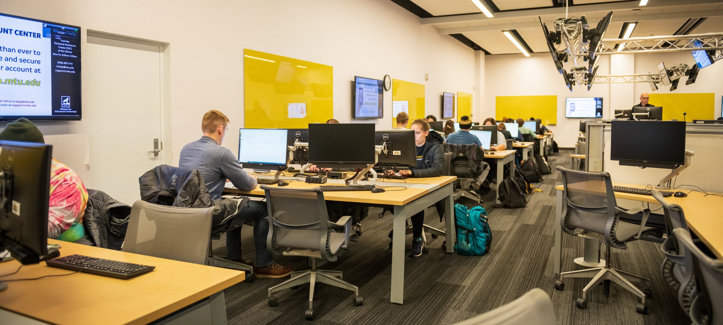 Accreditation and Objectives showing students in a technology classroom.