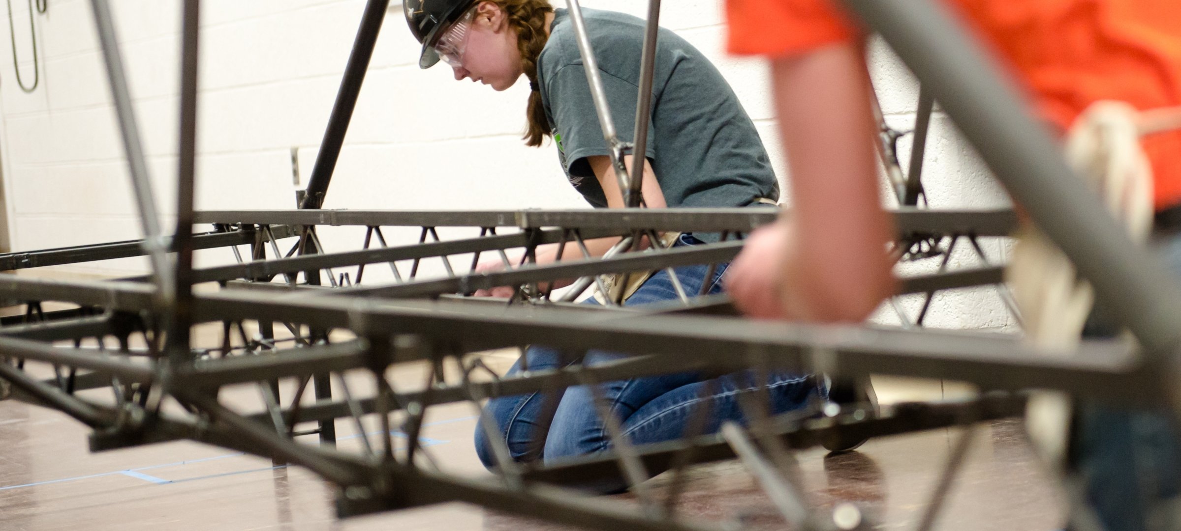 Students construction steel bridge for a competition.