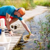 Student collecting water samples.