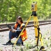 Student using surveying equipment.