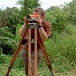 Person surveying in a jungle environment.