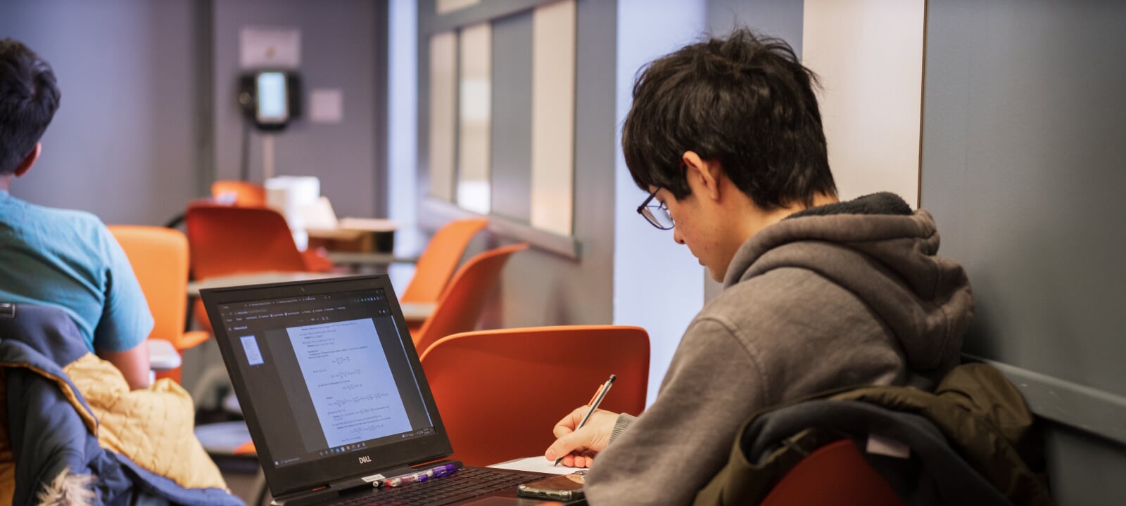 Student studying with a laptop.