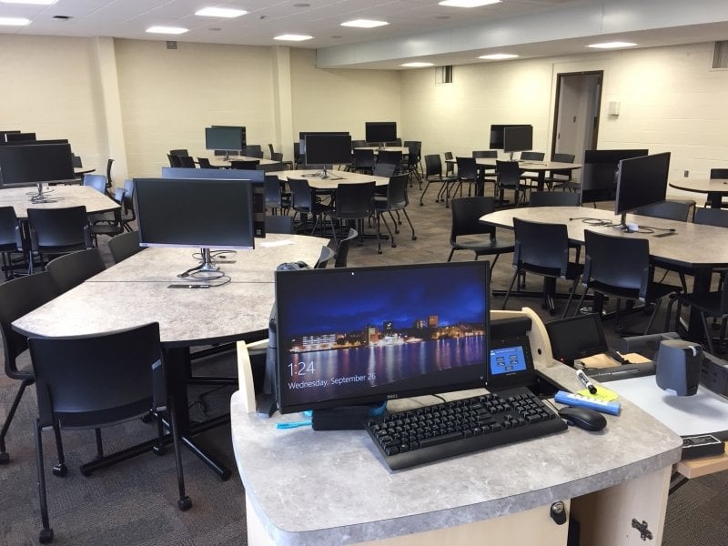 Dillman 208 showing 9 group tables, each with a pair of monitors and surrounded by chairs with casters.