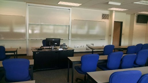 Fischer 325 showing rows of long retangular tables facing a lecture station and whiteboards.