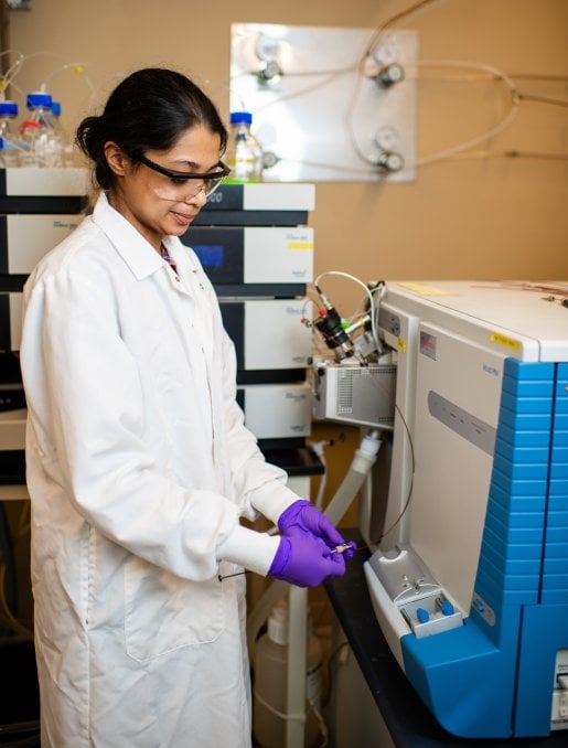 Researcher using mass spectrometer