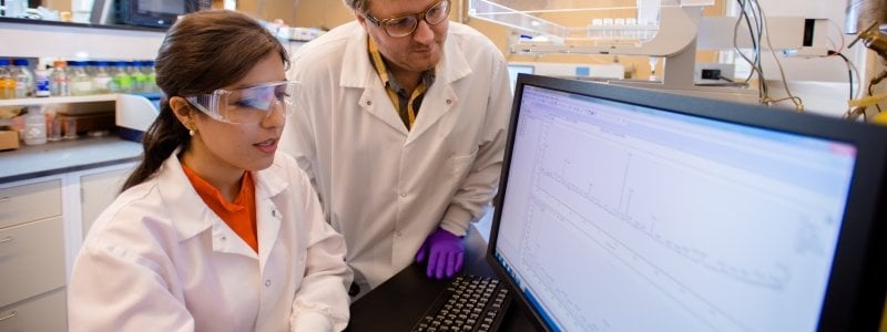 Two researchers looking a results on a computer.