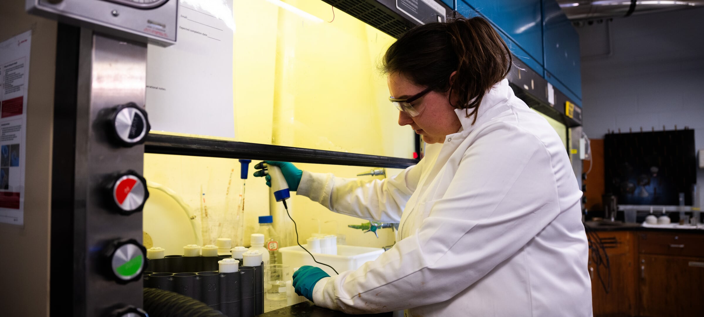 A student working with chemical engineering equipment.