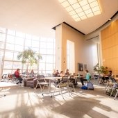 Students sitting at tables in the Library.