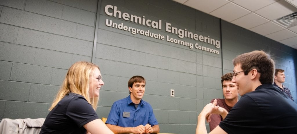 Students and coaches at a table in the learning commons.