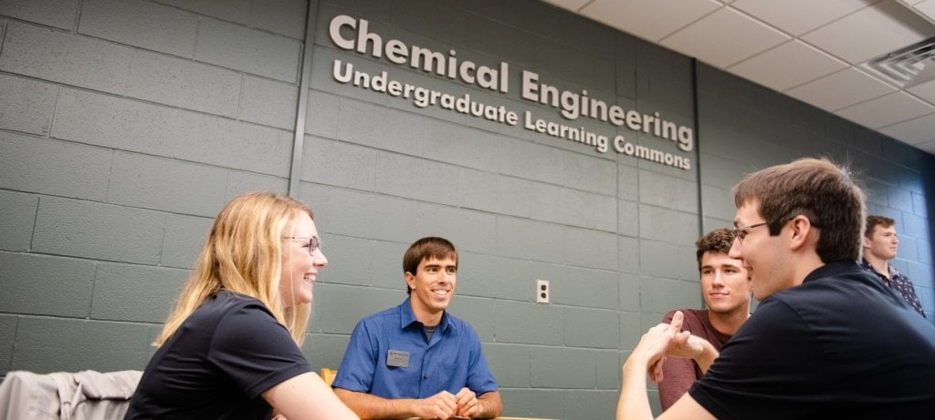 Students and coaches at a table in the learning commons.