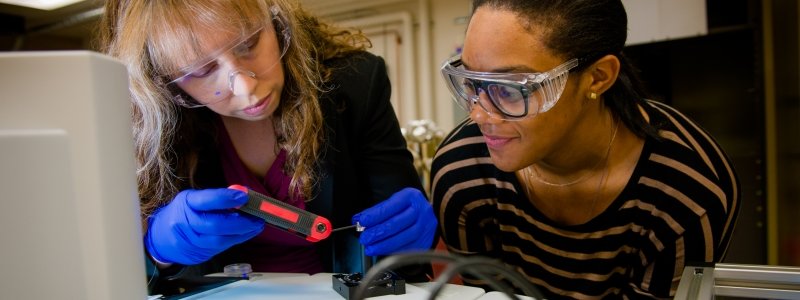 Two women using an allen wrench