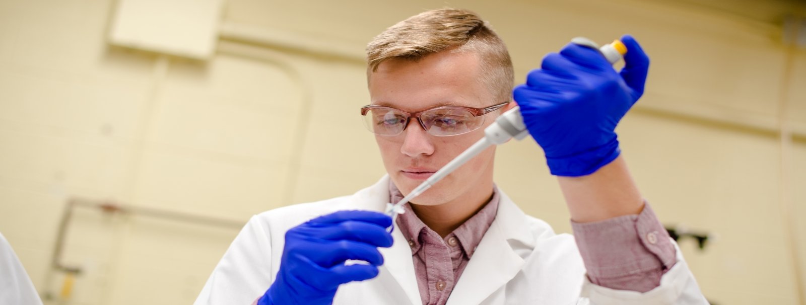 Chemistry student working in a lab.