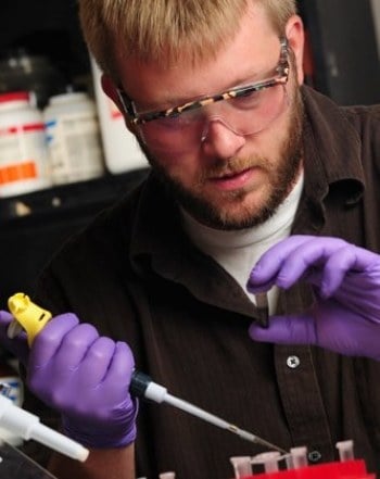 A man working with chemicals. 