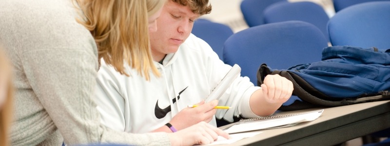 A student being helped in a classroom. 