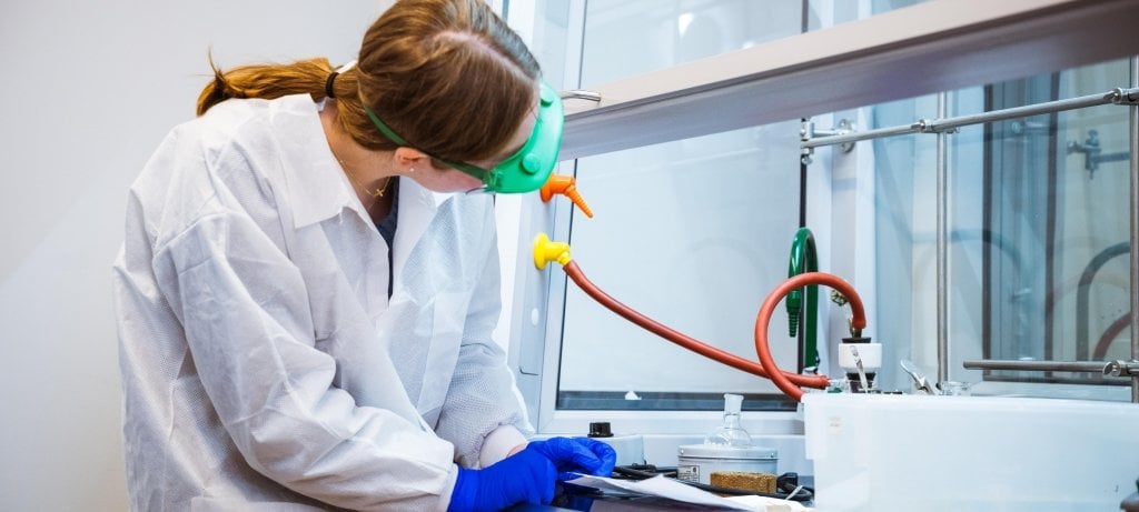 Woman in teaching lab with goggle and paper