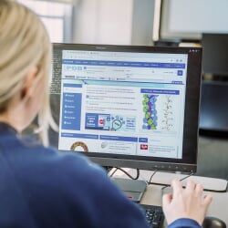Female chemistry student viewing data on a computer monitor