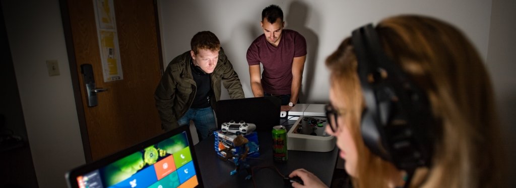 Two researchers record data while a participant completes an experiment.