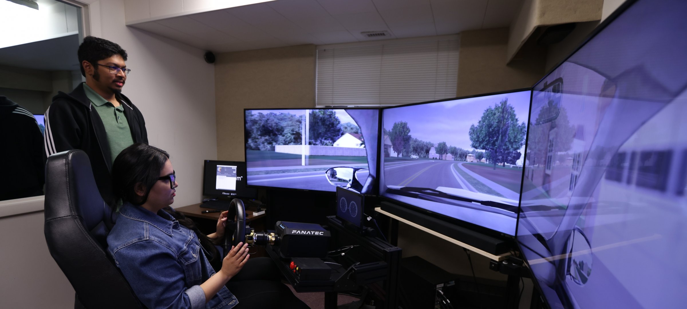 Two Students Testing on the Human Factors Auto Simulator