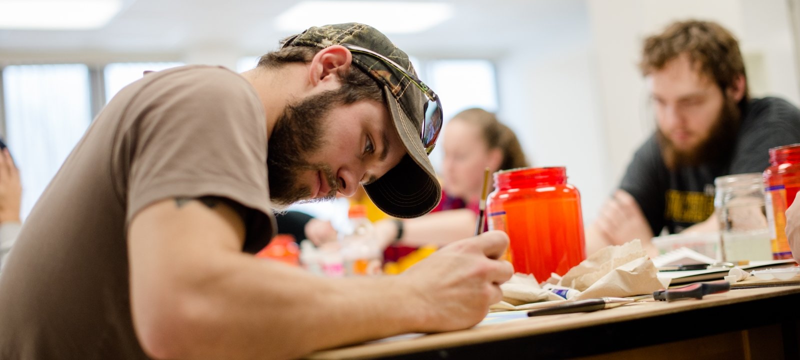 Psychology students working on color composition by painting.