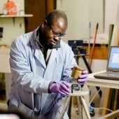 Student assembling equipment in a lab.